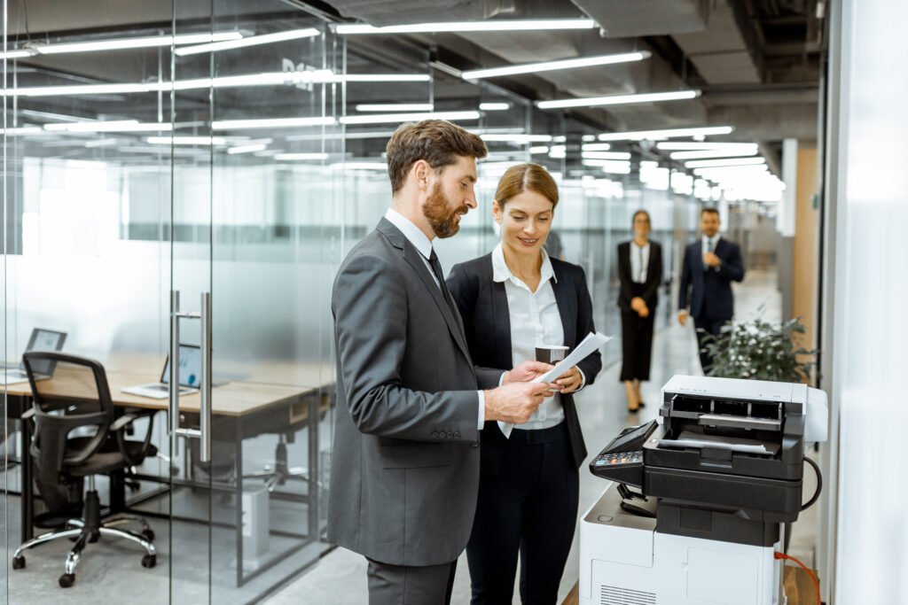 Business people near the copier in the hallway