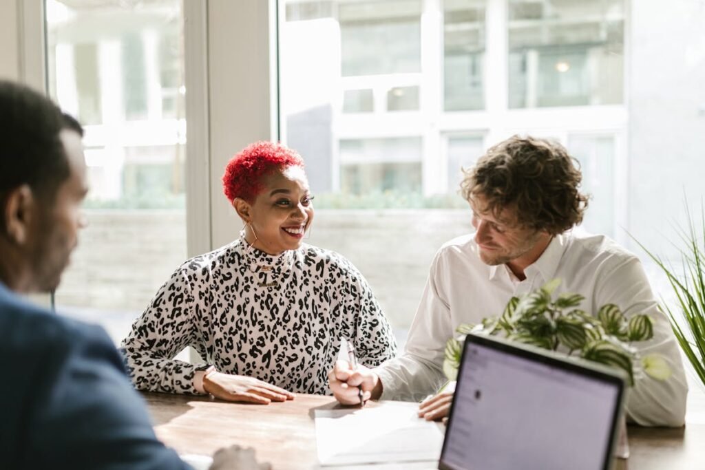 The 2026 Guide to Embedded Accounting: How Credit Unions Can Stop Losing Business Deposits 3 persons are discuss on finance managenment