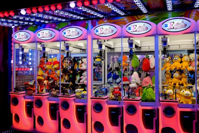 5 Tips to Keep Your Crane Prize Machine Running Smoothly A row of stuffed animals sitting inside of a vending machine